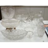 An early 20th century oval cut glass bowl on gilt metal stand, a pair of slice cut decanters and