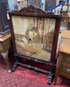 A Victorian rosewood firescreen inset polychrome tapestry panel, width 79cm, height 122cm