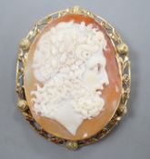 After the antique- A yellow metal mounted oval cameo shell brooch, carved with the head of a Zeus to