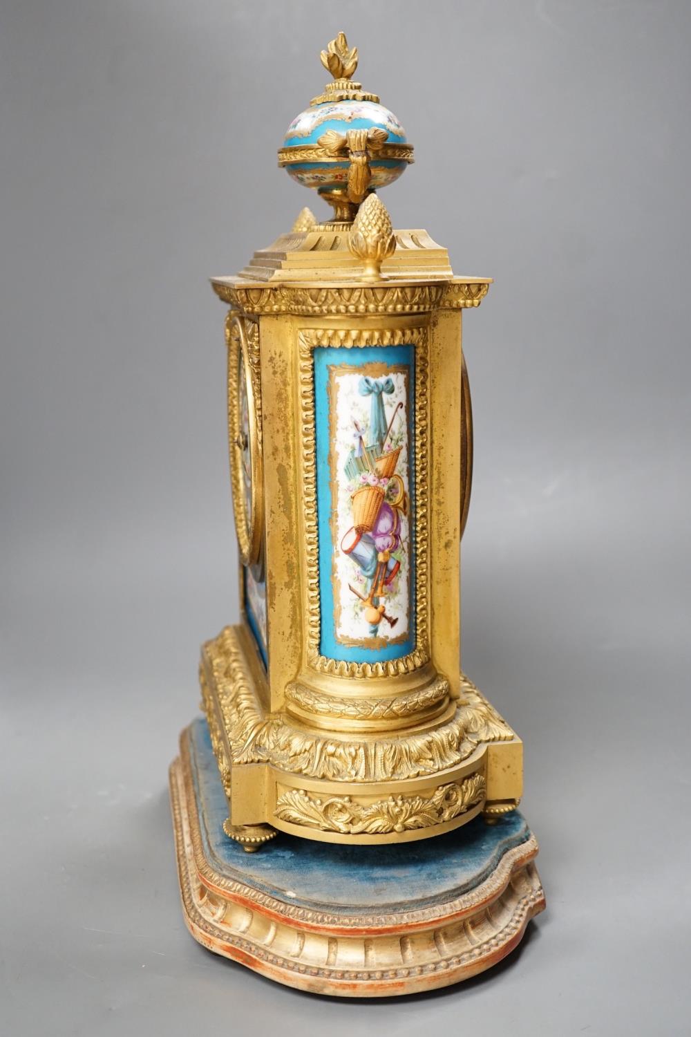 A French ormolu mantel clock, with inset floral decorated porcelain plaques and dial, 40cms high - Image 4 of 7