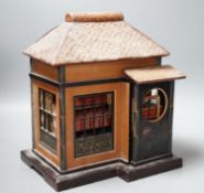 A Japanese lacquer 'house' with pitched wicker roof and opening side and front sections revealing