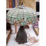 A spelter lamp with Tiffany style shade, 57cms high including shade