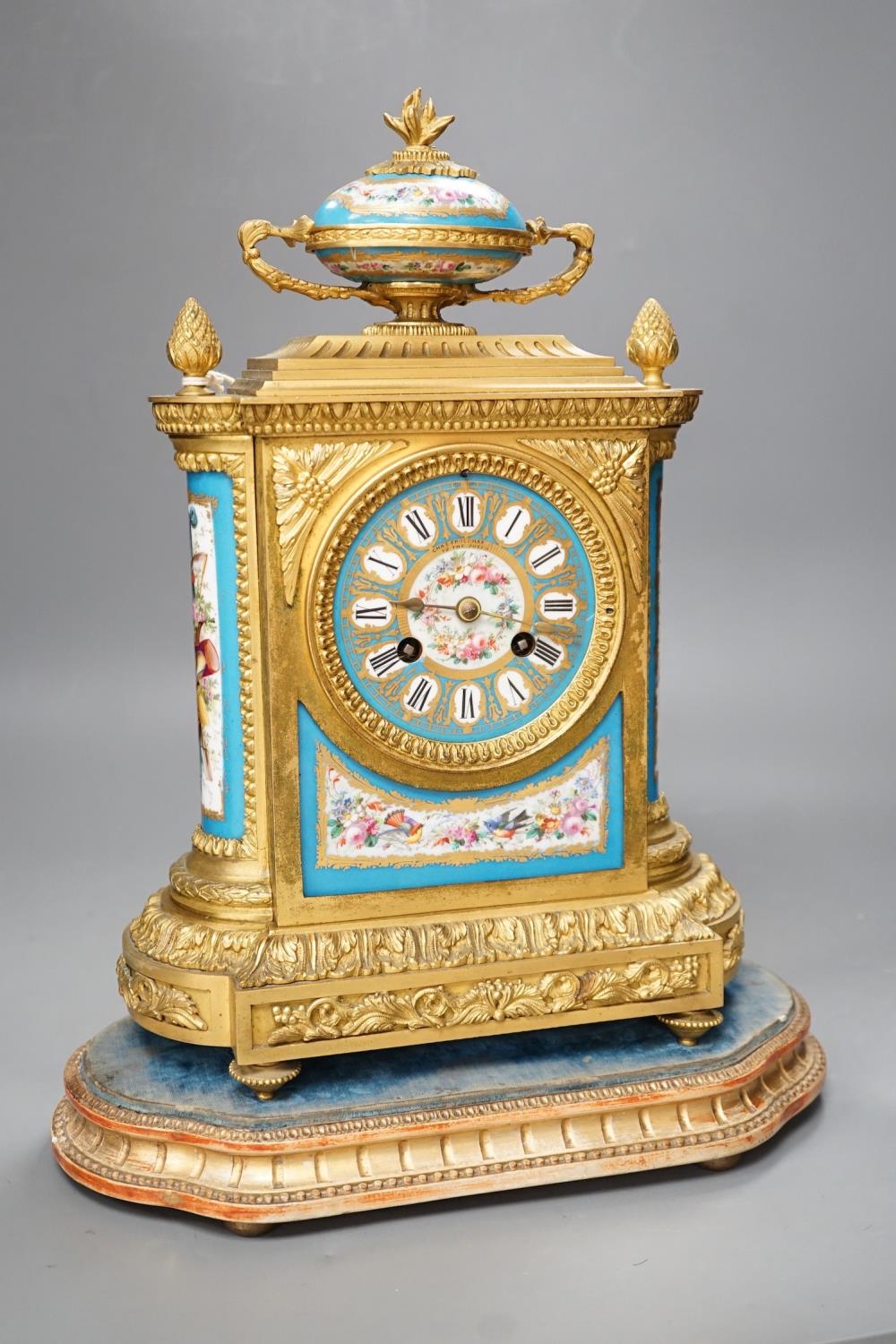 A French ormolu mantel clock, with inset floral decorated porcelain plaques and dial, 40cms high