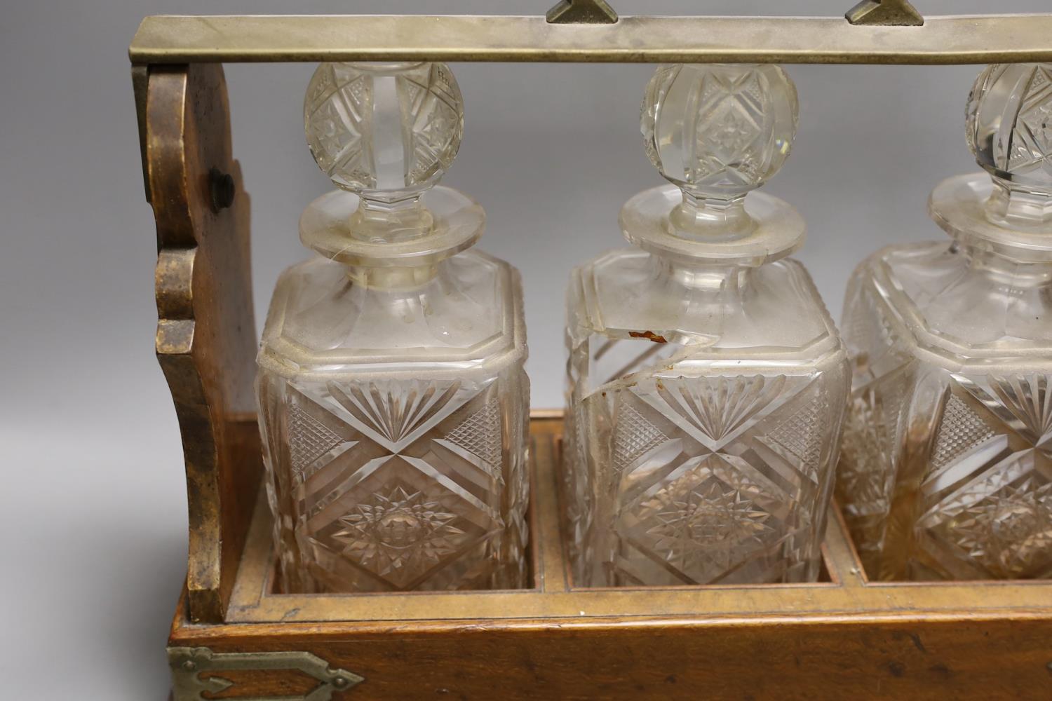 A Victorian Betjemann’s patent oak cased three bottle tantalus (a.f.), 42cms wide at base - Image 2 of 3