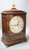 A Regency brass inlaid mahogany bracket clock, with pineapple finial, bears interior paper label