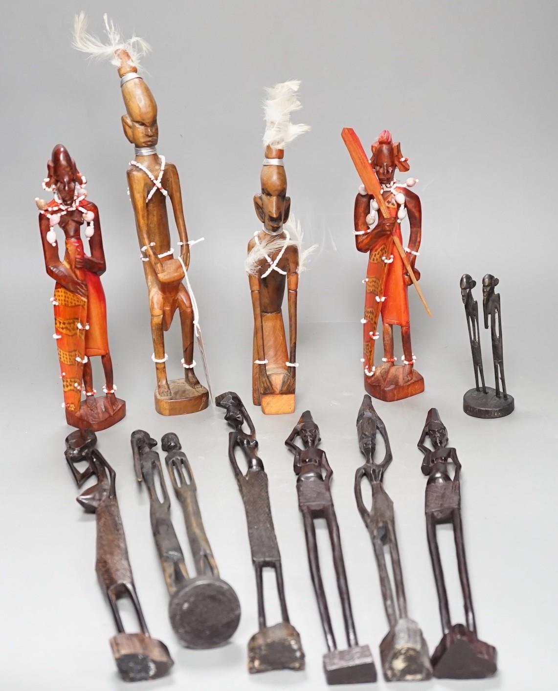 12 African carved wood stick figures, tallest 38cms high