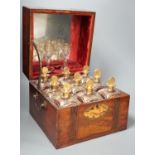 A 19th century Dutch inlaid mahogany decanter box containing nine gilt glass decanters and two