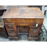 An 18th century feather banded walnut kneehole desk, width 81cms, depth 52cms, height 76cms.