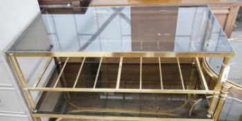 A brass and smoked glass two tier rectangular coffee table, width 99cm, depth 51cm, height 41cm