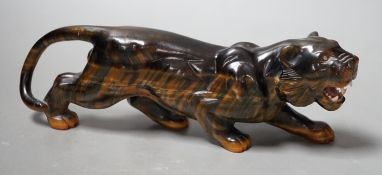A carved tigers eye model of a tiger with paste set eyes. Makers mark ‘WG’ to paw underside.