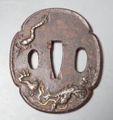 A Japanese Meiji silver and gold overlaid iron tsuba, 6.5cm high