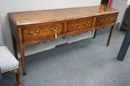A George III provincial oak and mahogany banded low dresser with three drawers on square tapering