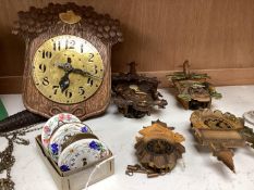 An early 20th century German Jugendstil oak wall timepiece, four miniature Black Forest timepieces