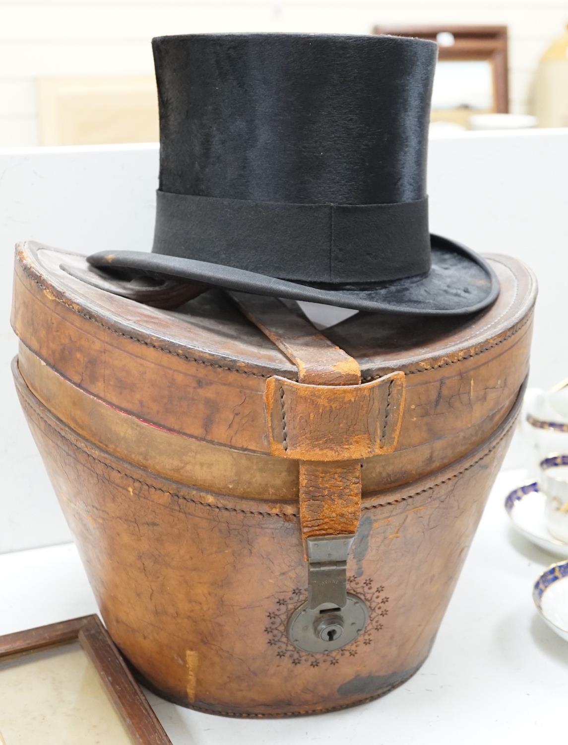 A Victorian top hat and kid gloves, leather cased