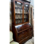 A George III inlaid mahogany bureau, with later top section, width 116cm, depth 51cm, height 232cm