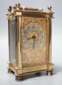 An Edwardian brass carriage timepiece, with pearl applied dial, 12cms high