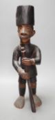 A late 19th century Belgian Congo carved wood figure of a sepoy Height 44 cm