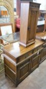 A reproduction 18th century style carved and linen fold moulded oak side cabinet and matching