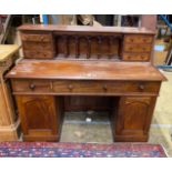 A Victorian style hardwood kneehole desk with galleried superstructure, length 140cm, depth 64cm,