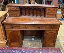 A Victorian style hardwood kneehole desk with galleried superstructure, length 140cm, depth 64cm,