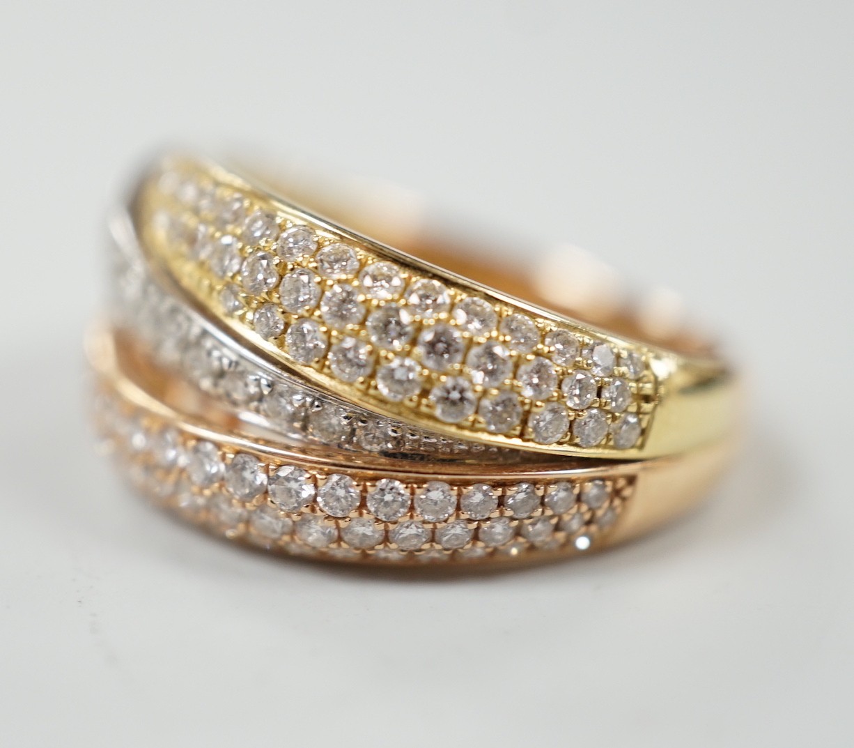 A modern three colour 18ct gold and diamond chip cluster set three row crossover ring, size O, gross - Image 2 of 4