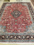 A Sarough red ground carpet, 335cm x 248cm