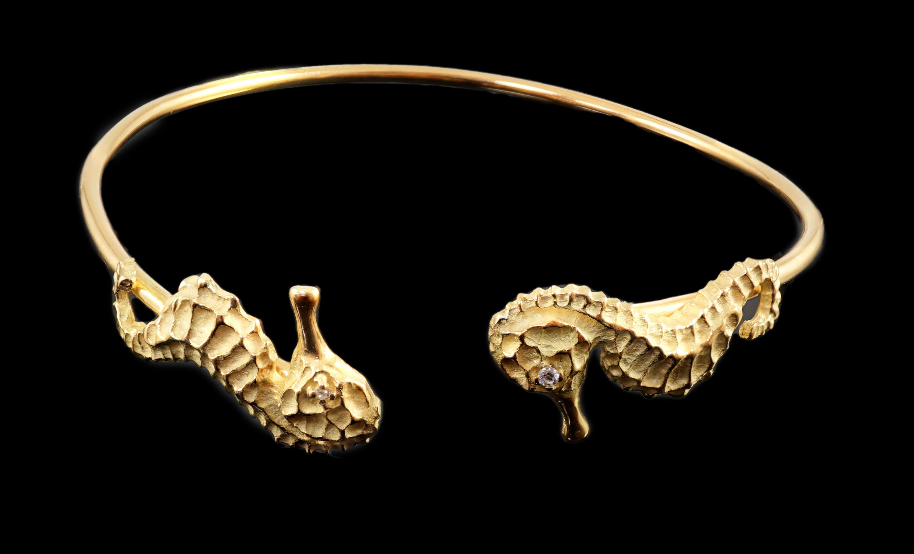 A modern gold and diamond chip set open work bangle, each terminal modelled as a seahorse with - Image 2 of 6