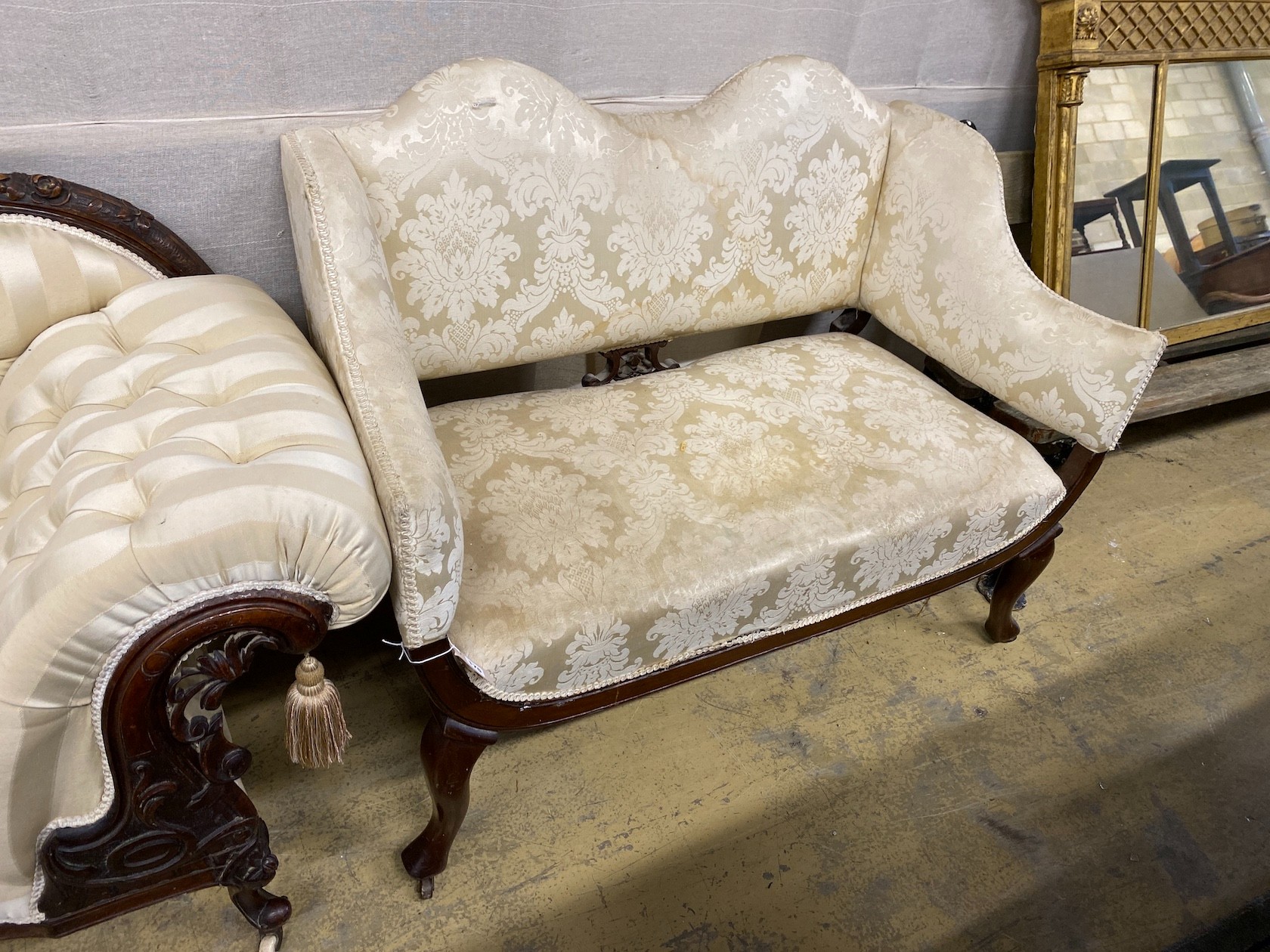 A late Victorian upholstered mahogany framed settee in cream damask, length 124cm, depth 68cm,