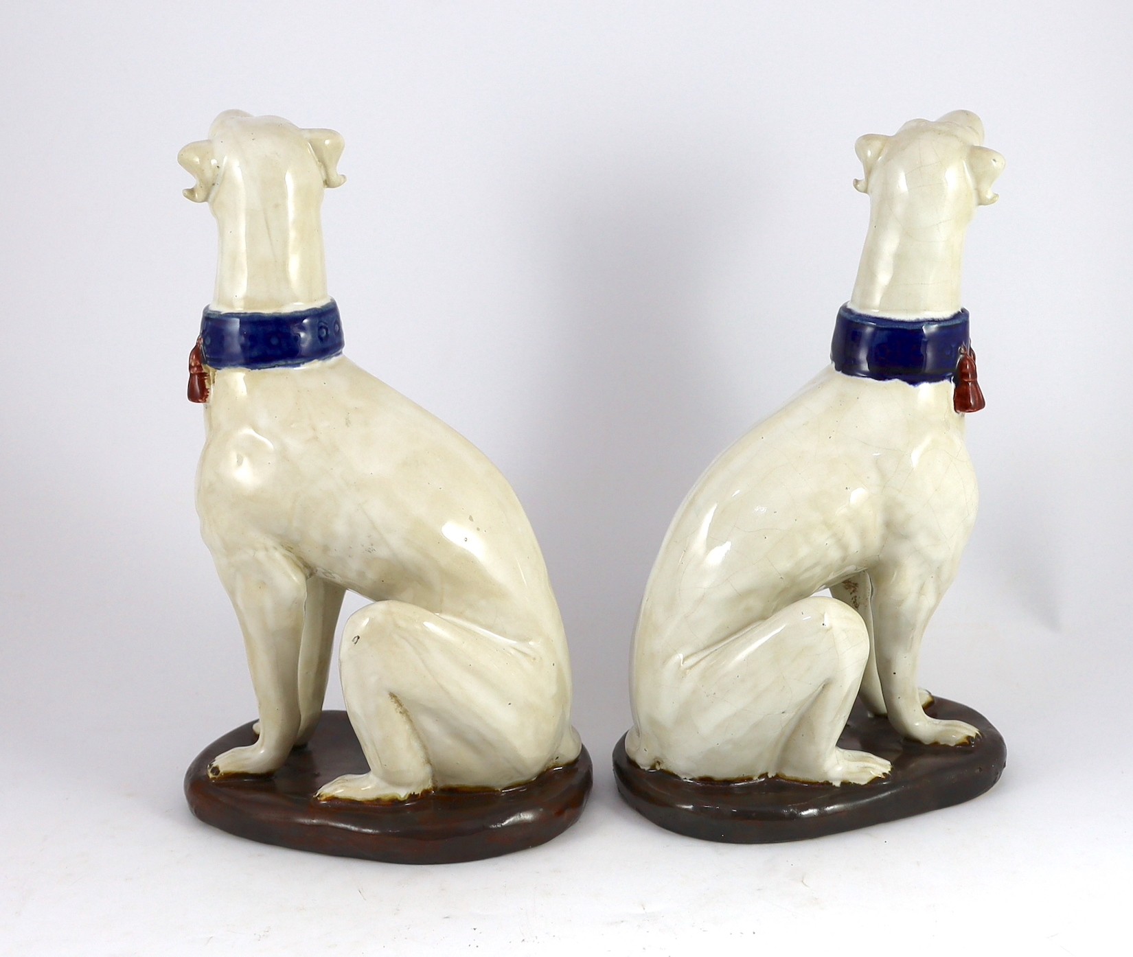 A pair of Italian tin-glaze earthenware figures of seated greyhounds, 35cm high - Image 2 of 4