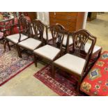 A set of seven George III style mahogany dining chairs, one with arms, together with a similar elbow