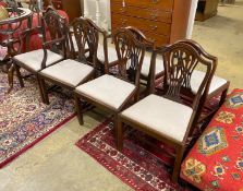A set of seven George III style mahogany dining chairs, one with arms, together with a similar elbow