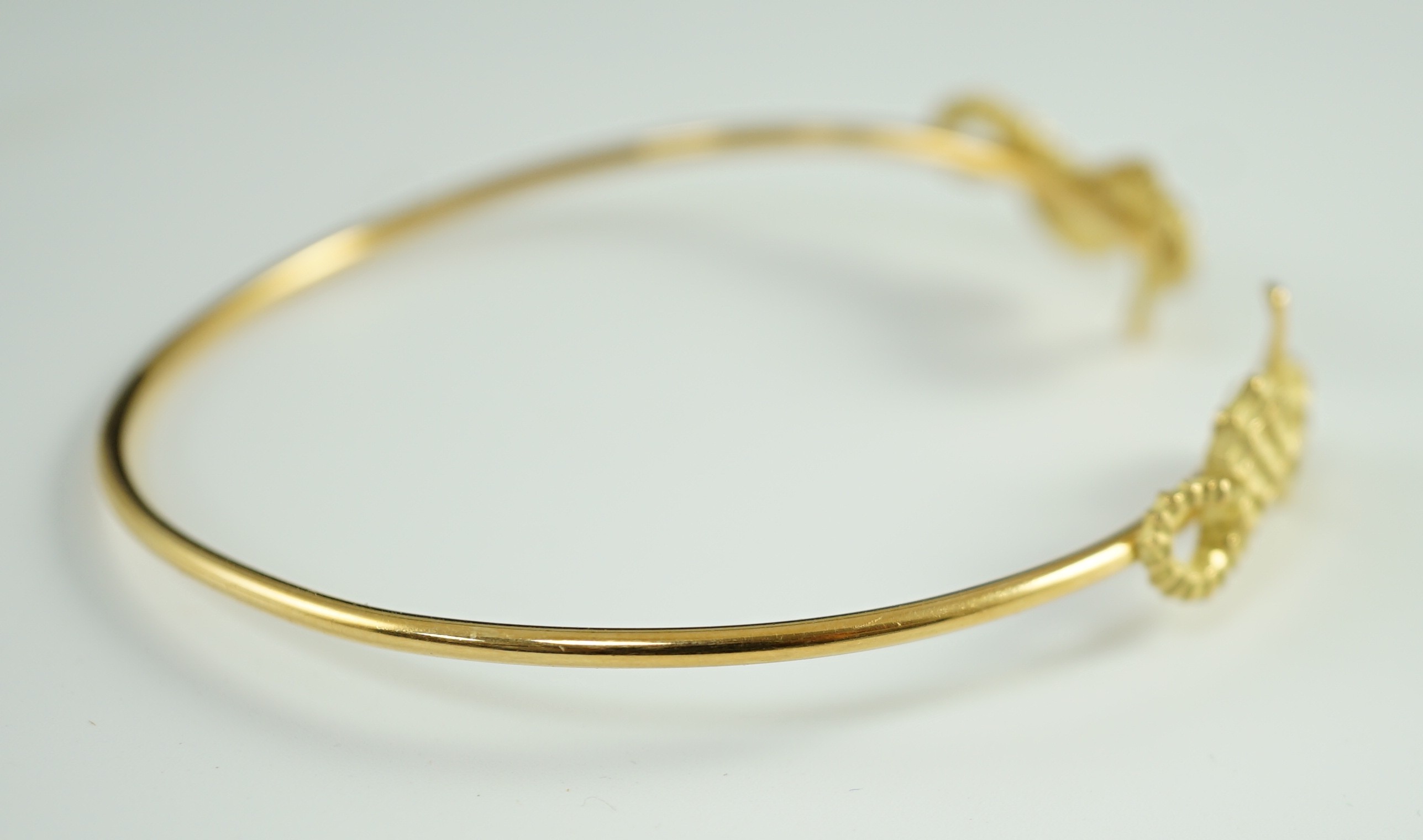 A modern gold and diamond chip set open work bangle, each terminal modelled as a seahorse with - Image 5 of 6