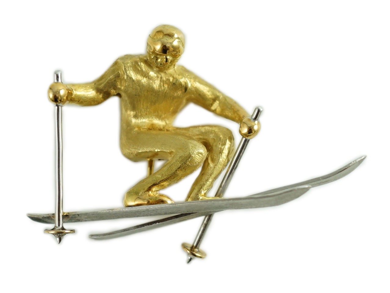 A gold and platinum novelty brooch modelled as a skier, length 39mm, 9.3 grams.