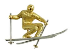A gold and platinum novelty brooch modelled as a skier, length 39mm, 9.3 grams.