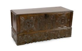 An 18th century Spanish chestnut coffer, carved in relief with a central fountain flanked by