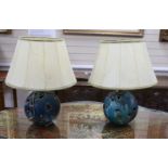 A pair of pierced pottery table lamps with vellum shades