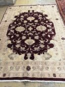 A Heriz burgundy ground carpet 275cm x 200cm.