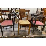 A pair of late Victorian style corner elbow chairs and a rush seat chair