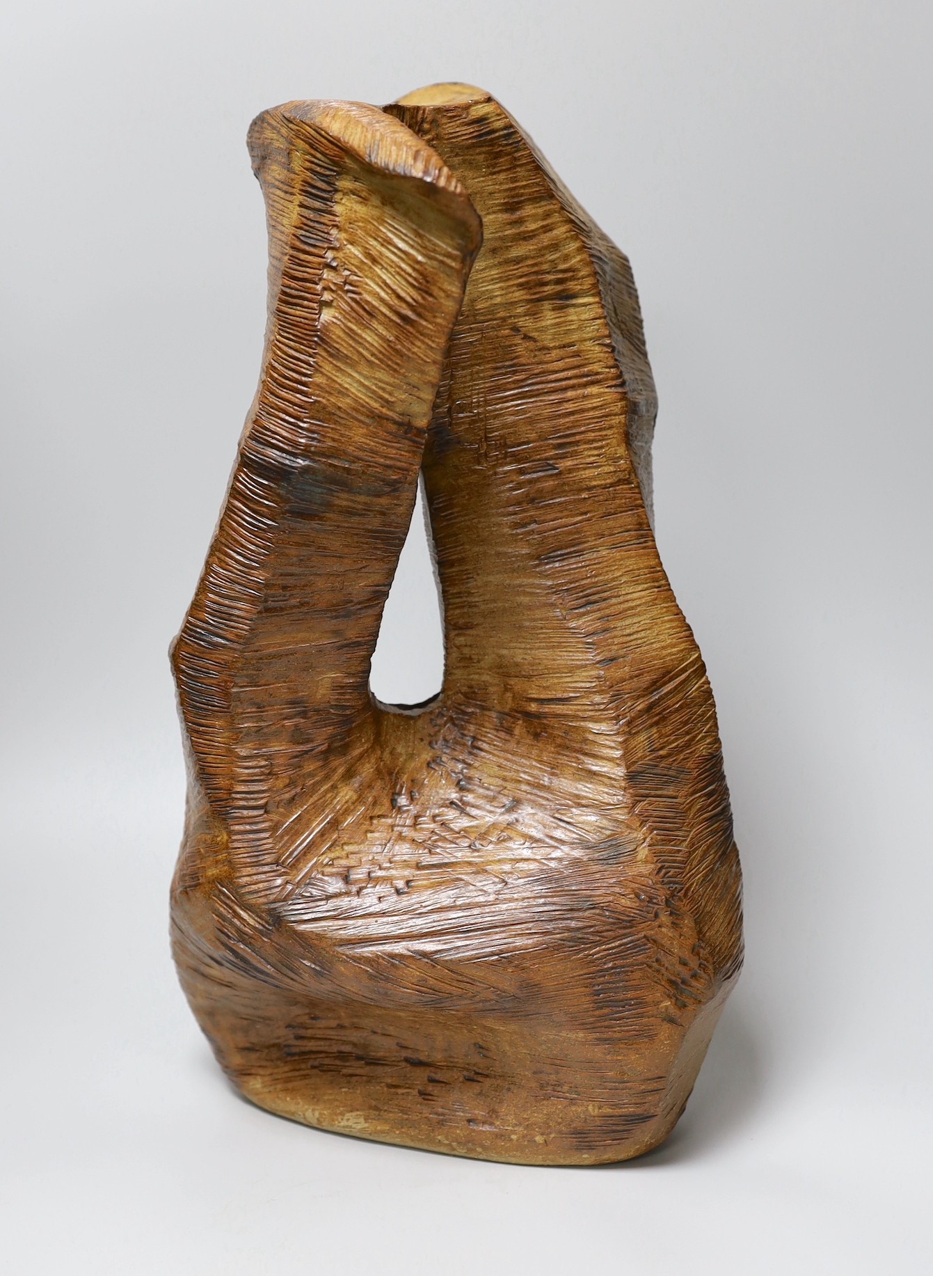 Ruth Sulke - a large brown copper glazed stoneware angular “wooden” sculpture with central hole,