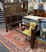 A 17th century style carved oak single head and foot bedstead, length 210cm, width 127cm, height