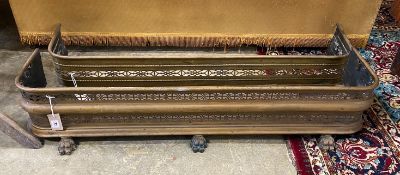 Two Victorian pierced brass fenders, larger width 121cm