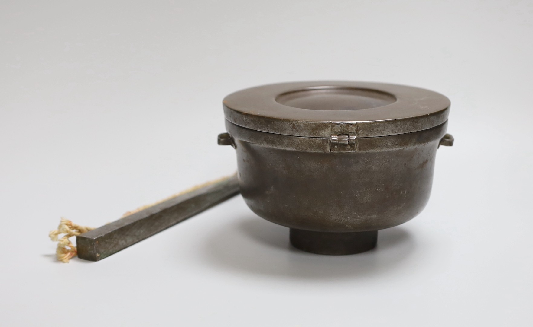 A Tibetan stunning weight and a Tibetan saddle storage pot