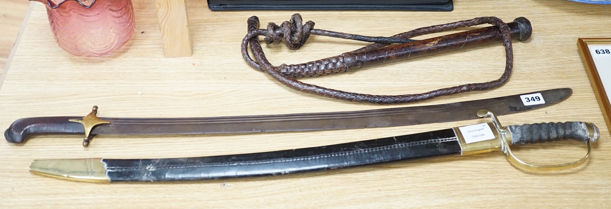 An Ottoman tulwar sabre, a European sabre and a leather whip