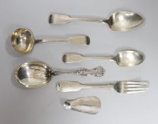Four assorted items of silver flatware, a sterling serving spoon and a George V silver shoe horn (