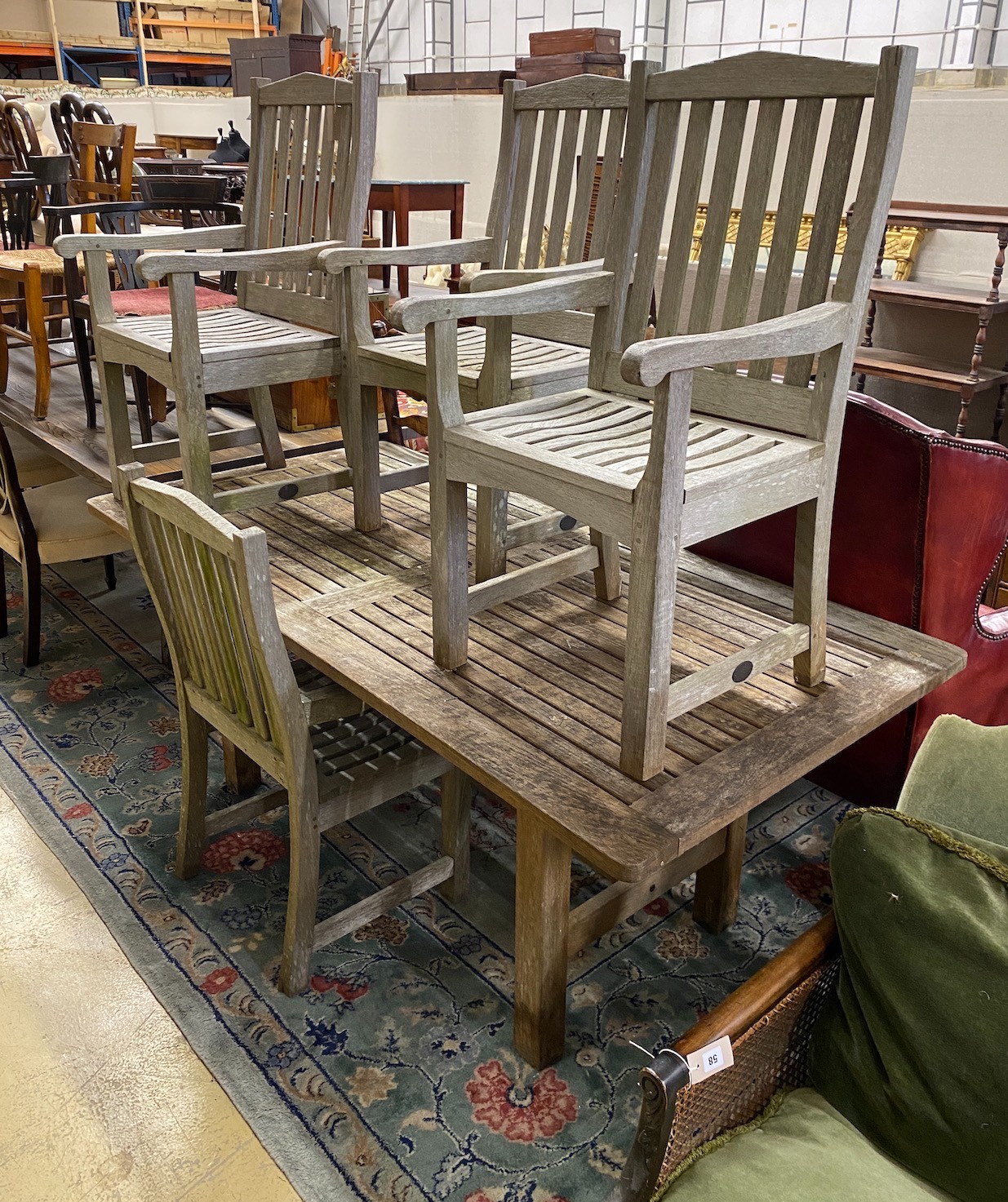 A rectangular weathered teak garden table, length 183cm, depth 92cm, height 73cm and four Lister