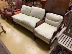 An early 20th century mahogany two piece bergere suite, settee length 130cm, depth 70cm, height