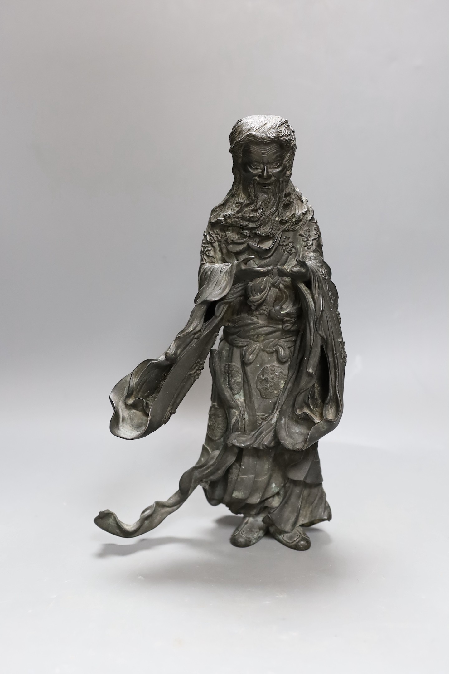 A heavily cast Japanese bronze figure of a bearded man with flowing robes, Meiji period, 31cm tall