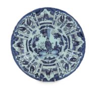A Delft blue and white Kraak style dish, late 17th century, the centre painted with a Chinese figure