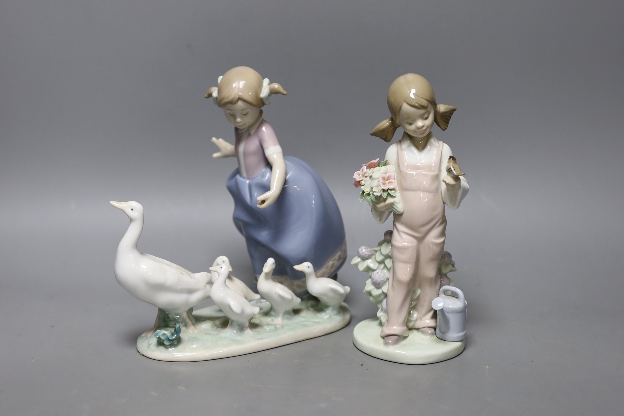 A boxed Lladro figure and another