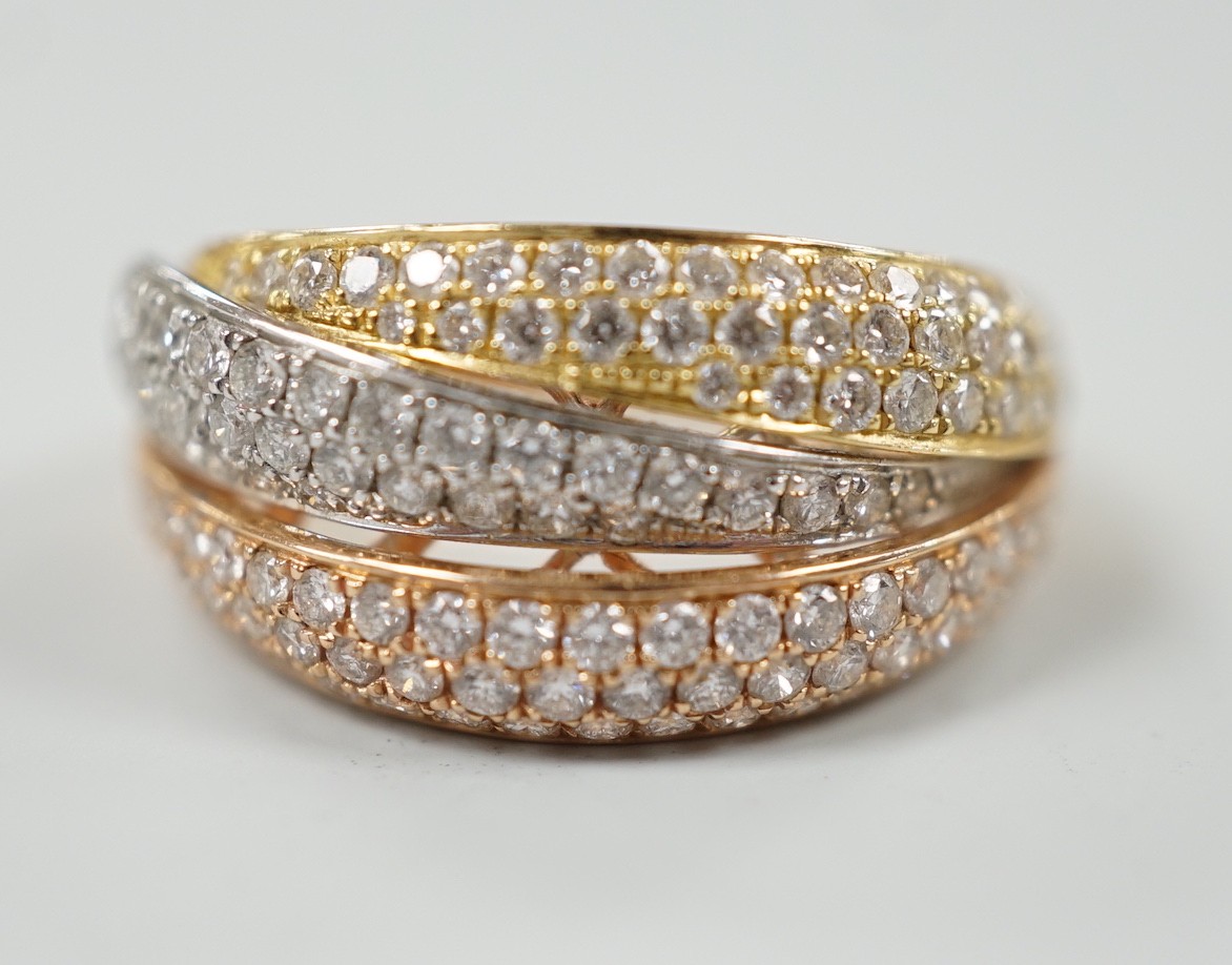 A modern three colour 18ct gold and diamond chip cluster set three row crossover ring, size O, gross